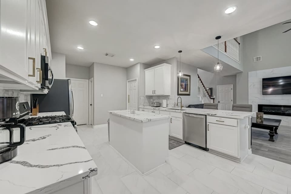 Open kitchen layout featuring a large island, ample counter space, and direct view to the living area.

