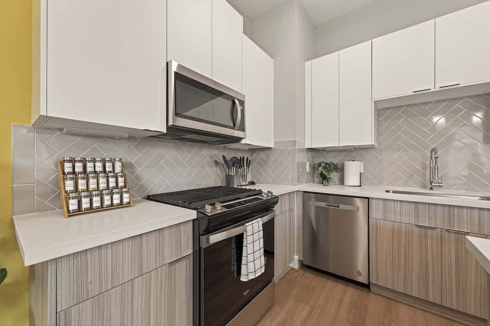 Cook in style with stainless steel appliances and a spacious island. Includes leather bar seating and elegant pendant lighting for a social atmosphere.