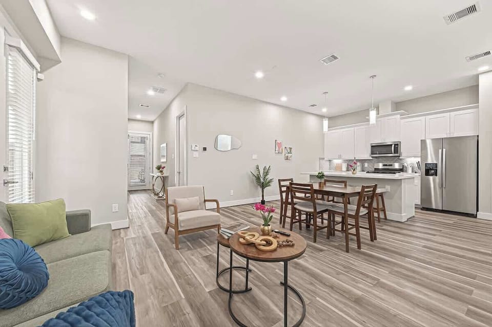 Spacious open-concept living, dining, and kitchen area with modern finishes, natural light, and comfortable seating—ideal for relaxing, dining, and entertaining.