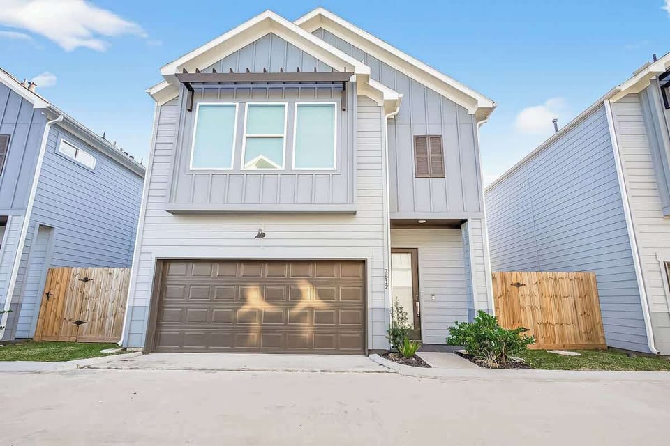 Modern two-story townhome with private garage, fenced yard, and stylish exterior—ideal for comfortable short- or long-term stays.