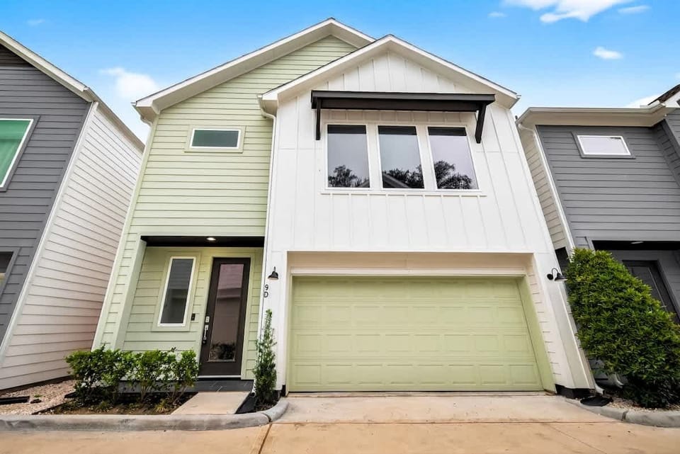 Contemporary façade featuring sleek lines, large windows, and a spacious garage.