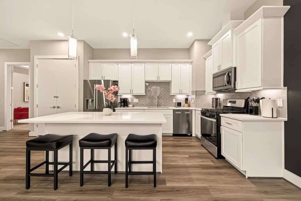 A stylish, fully equipped kitchen with ample counter space and a welcoming island perfect for cooking and conversation.