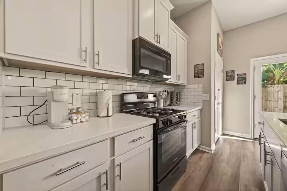 Kitchen: Whip up culinary delights in this modern, well-equipped space with bright, airy vibes!