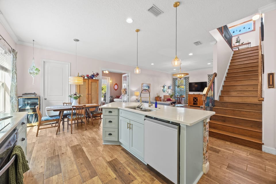 “Spacious open layout with kitchen, dining, living room, and upstairs access — ideal for families.”
