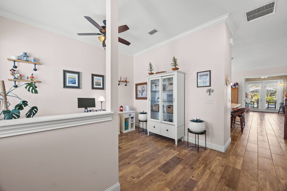 Bright hallway leading to patio and pool — seamless flow between indoor and outdoor spaces.