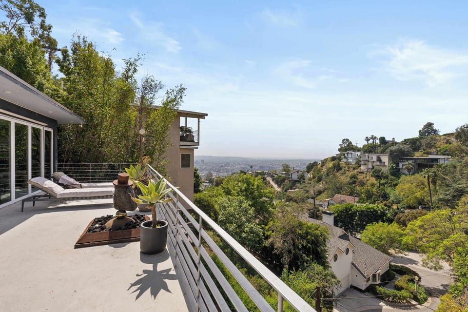 Upper Terrace with Lounge Chairs & Panoramic Hillside Views