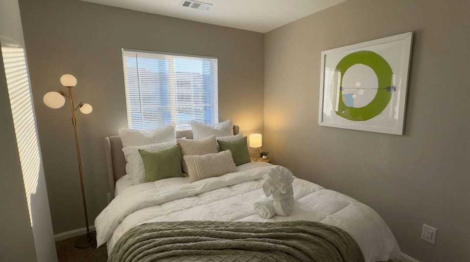 King bedroom with bedside lighting and natural light