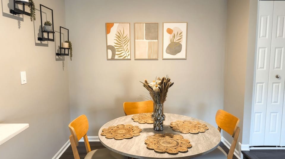 Dining area with four chairs and botanical wall art