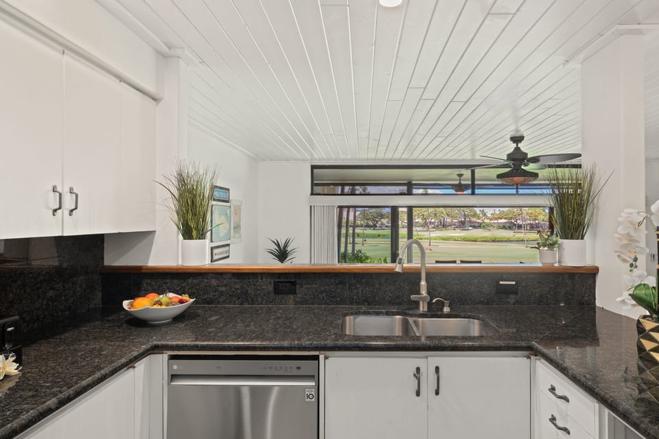 Kitchen sink area overlooks the golf course through a wide picture window.