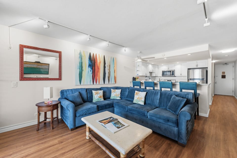 Open-concept living room with generous seating and tropical-inspired décor.
