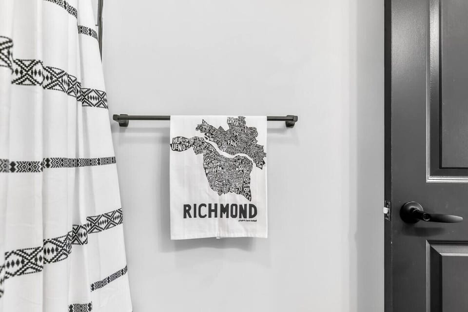 A sparkling, modern full bath featuring a luxe shower‑tub combo with shower-tower head and plush towels. Your spa‑style refresh awaits—complete with the home’s signature massaging LED shower tower experience.
