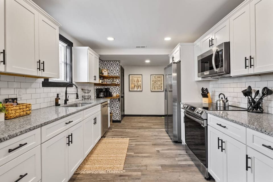 A bright, wide‑galley kitchen with a dreamy coffee nook (drip, Keurig & French press), deep basin sink, and all the essentials for elevated at‑home cooking.