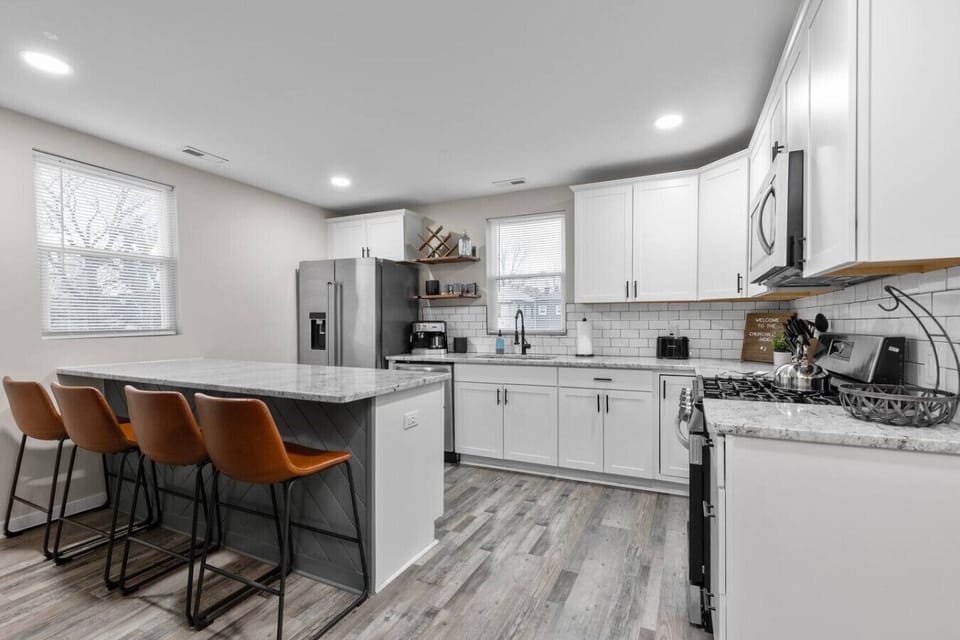 A fully equipped eat‑in kitchen built for effortless cooking and gathering, featuring a spacious island for four, a large basin sink, sleek appliances with an ice machine, and both espresso and drip coffee options to keep you peppy!