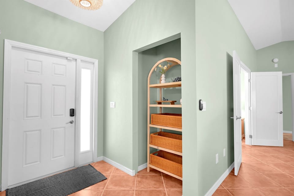 Front entry - Walk in to the home and instantly see the open living area, and back lanai, heated pool and lounge area