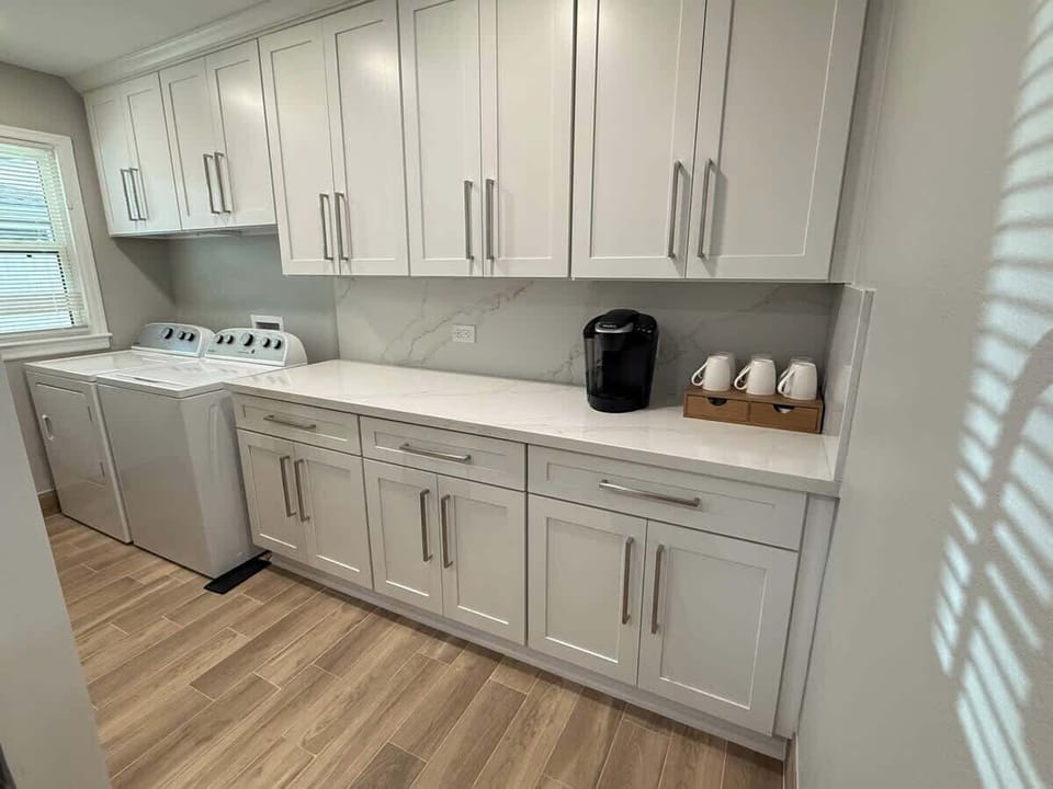 Laundry room and coffee bar are next to the open concept kitchen area