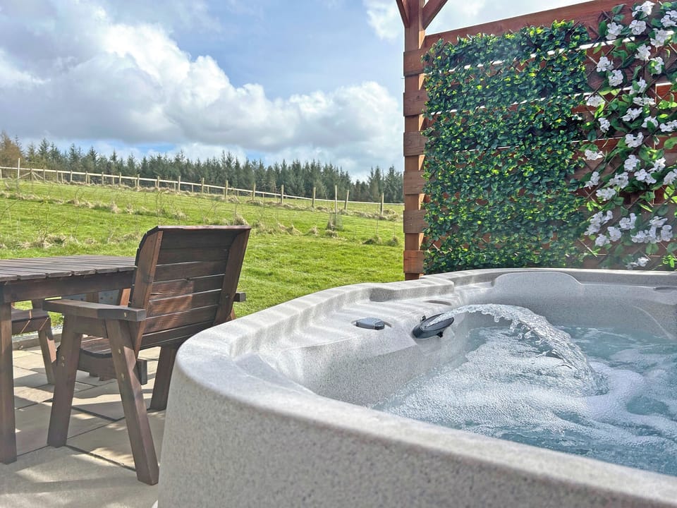 Exterior hot tub with covered pergola | Rose Pod - Barnharrow Holiday Pods, Newton Stewart