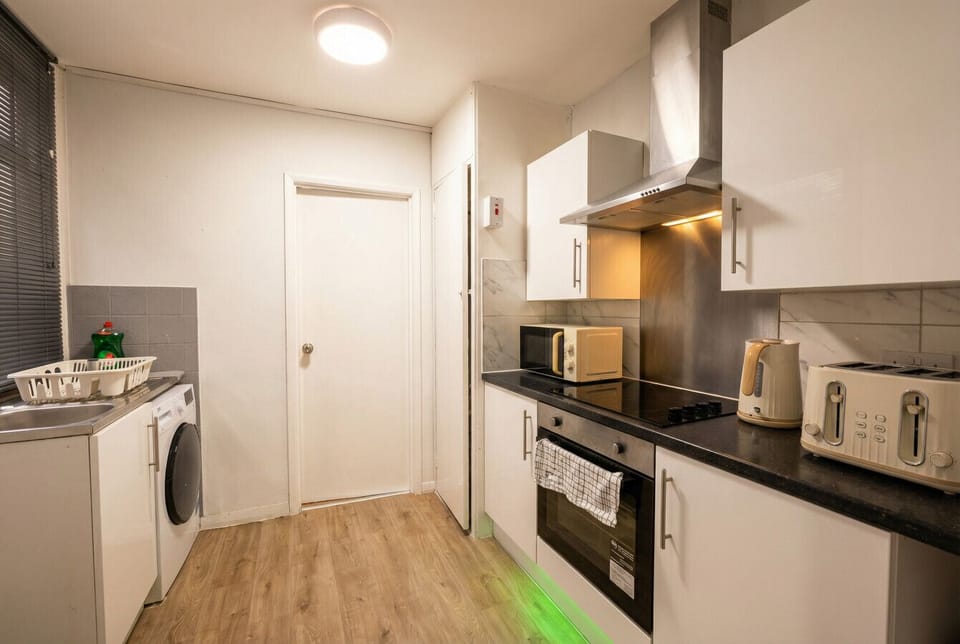 Everything you need in one place, with a washing machine tucked alongside the full kitchen for longer stays.