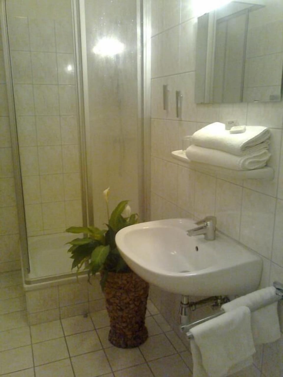 Shower, hair dryer, slippers, towels
