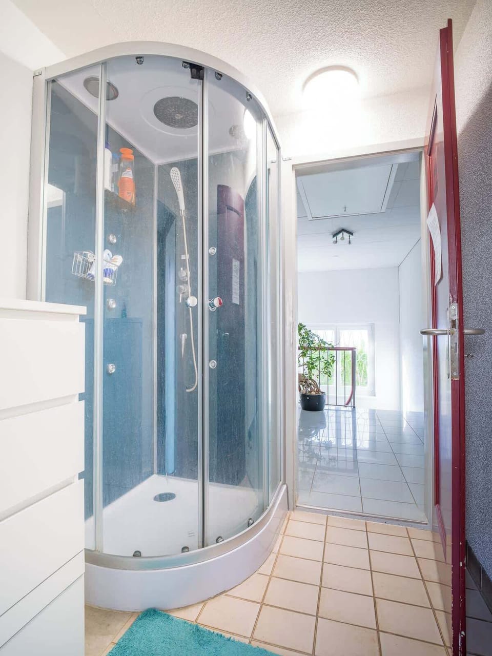 Spacious bathroom with shower cabin and storage