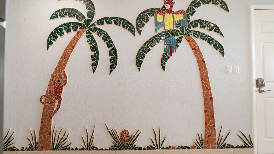 Cool tiled mural in the living room groom.