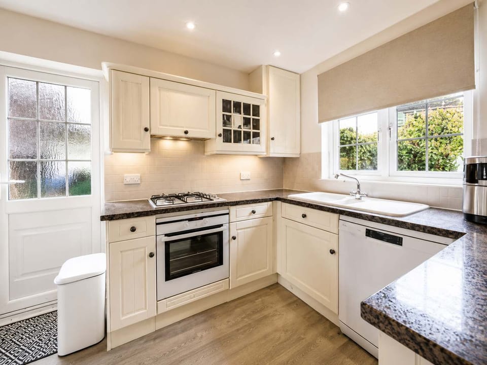 Charming Kitchen: Whip up culinary delights in a sunlit space with modern appliances!