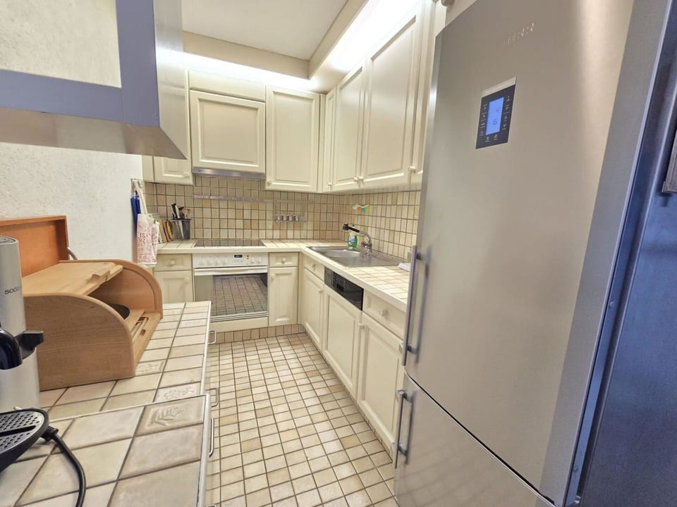 Flooring, Kitchen, Floor, Countertop, Kitchen Appliance, Major Appliance, Interior Design, Cabinetry, Home Appliance, Tile