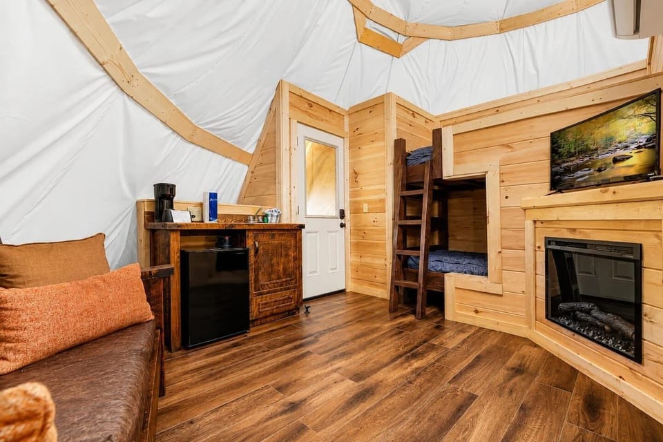 Inviting living room featuring bunk beds, Smart TV, WiFi, heating, air conditioning, and a cozy atmosphere designed for comfortable Smoky Mountain stays with family and friends.