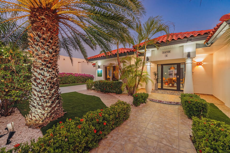 Welcoming front entrance with warm lighting and tropical details