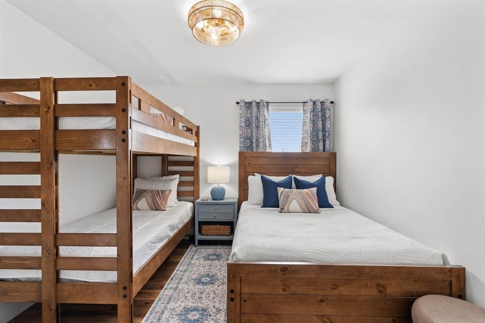 Drift off in your cozy bedroom featuring a comfortable queen bed and fun bunk beds, perfect for families or friends sharing memories together.