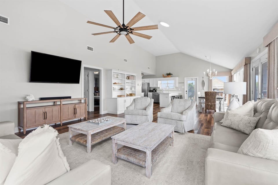 Unwind in this elegant open-concept living space featuring plush seating, modern amenities, and coastal-inspired decor for your perfect getaway.