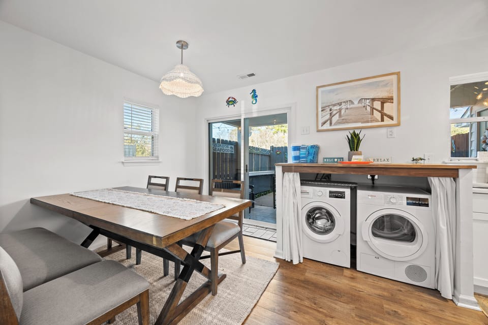 Enjoy your meals at this beautiful dining table while having convenient laundry access tucked beneath the counter.