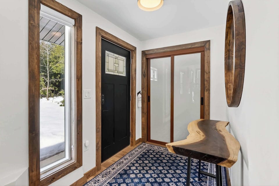 Step into your welcoming entryway where warm wood accents and stylish details create the perfect first impression of your mountain retreat.