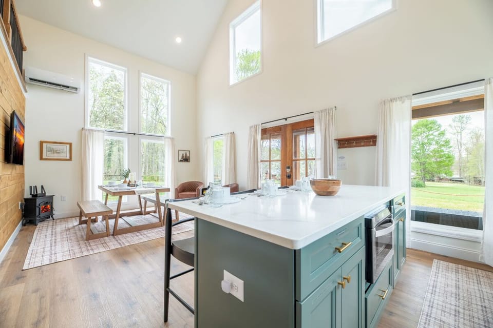 Your bright, open kitchen and dining space features stunning high ceilings and panoramic windows that flood the room with natural light.