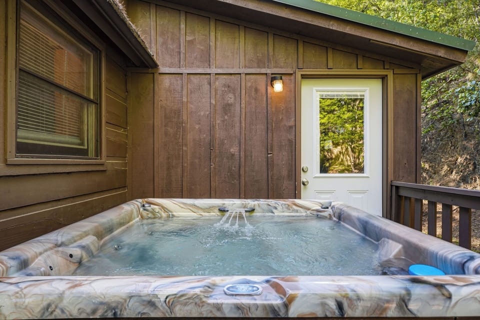 Soak your worries away in your private hot tub, surrounded by serene forest views and rustic charm.
