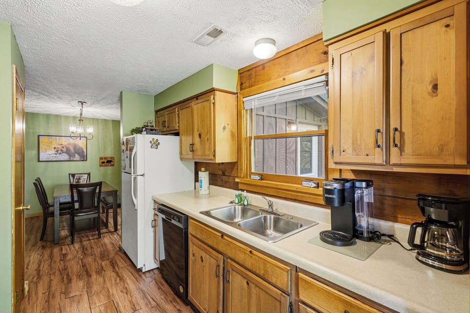 Your fully equipped kitchen features warm wood cabinets and modern appliances, perfect for preparing meals during your stay.