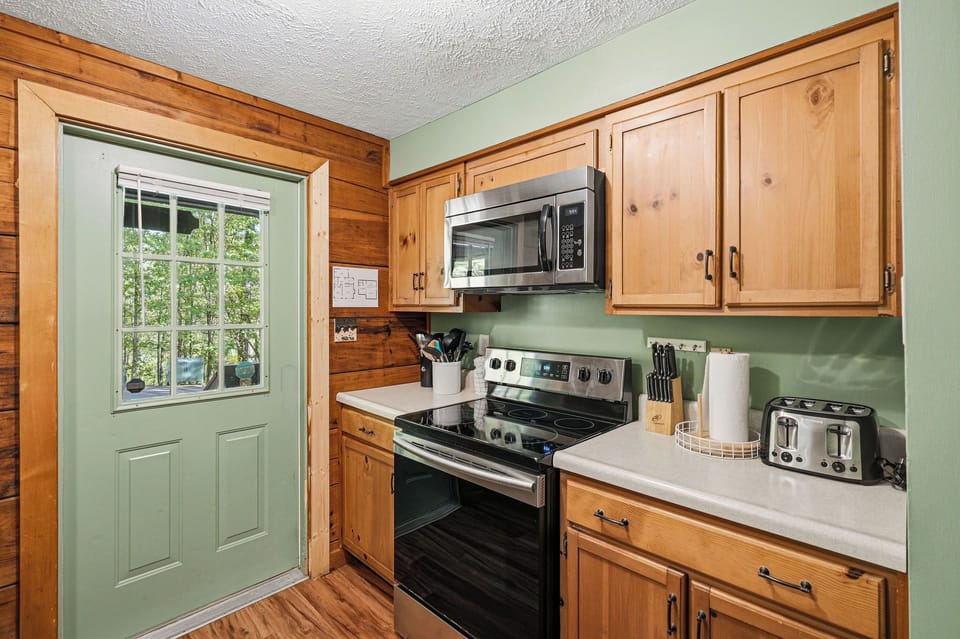 Your fully equipped kitchen features warm wood cabinets and modern appliances, perfect for preparing home-cooked meals during your stay.