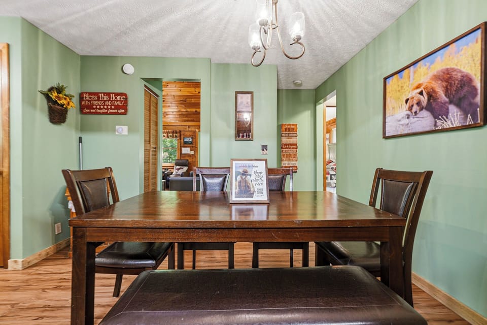 Gather around this welcoming dining table where your group can share stories and create memories together in this cozy, rustic-themed space.