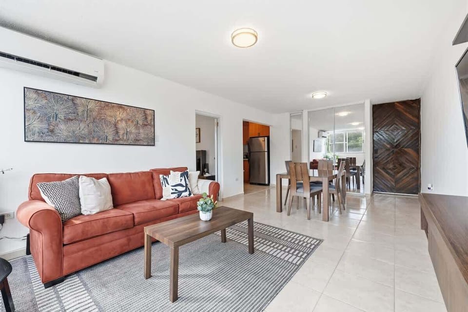 Open-concept living and dining area with warm tones and modern finishes.