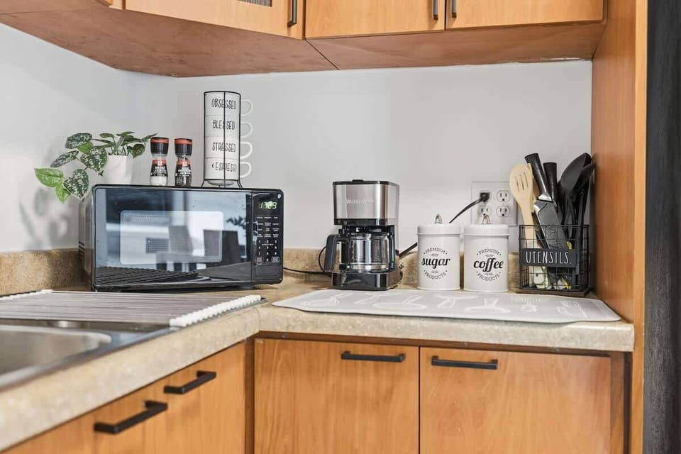 Cozy kitchen corner set up with coffee station and everyday appliances.