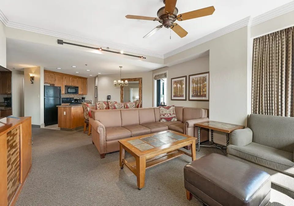 Open-plan living area with large windows, a dining table, and enough space for everyone after a day outdoors.