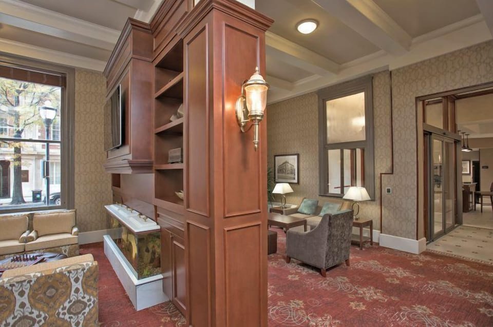 Lounge area with warm wood accents and large windows — pull up a seat after a day at Inner Harbor