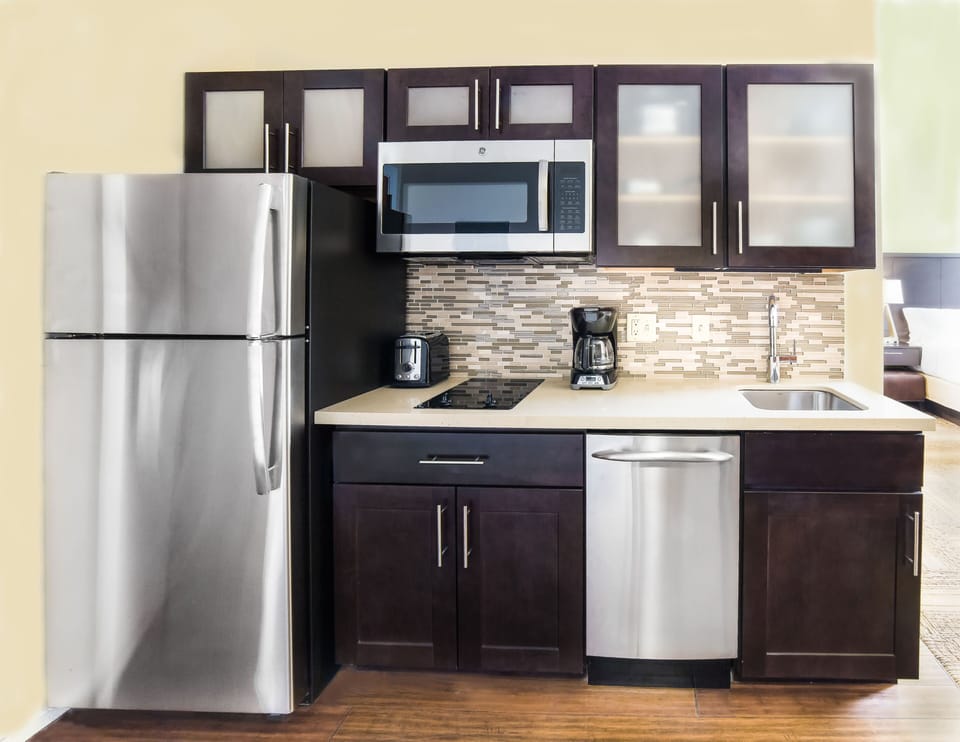 Modern kitchen with stainless steel appliances and chic cabinetry design.