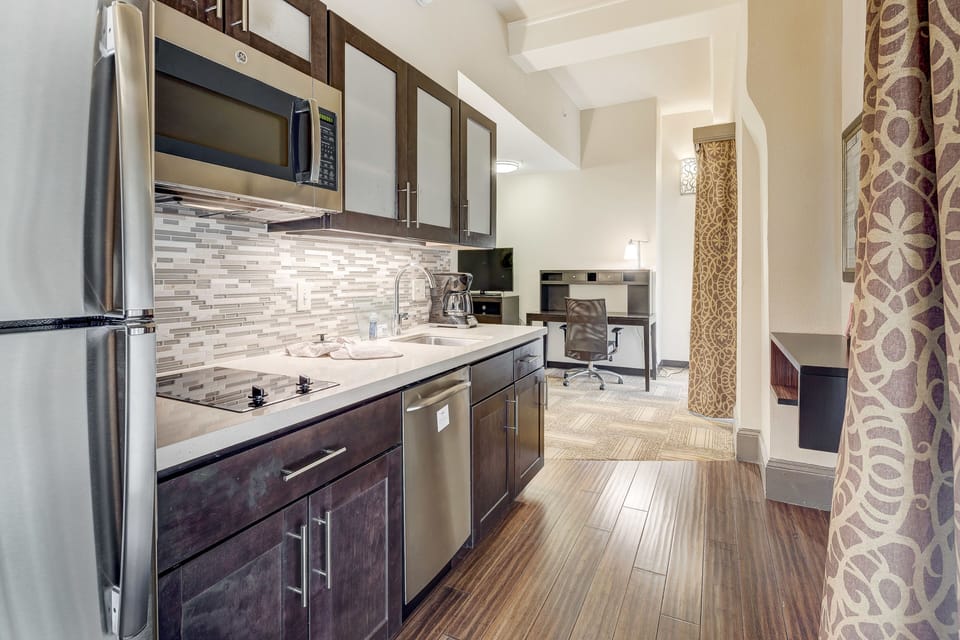 Functional kitchen with stainless steel appliances and stylish finishes.