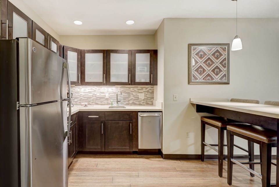 Functional kitchen layout showcasing cabinetry and modern backsplash.