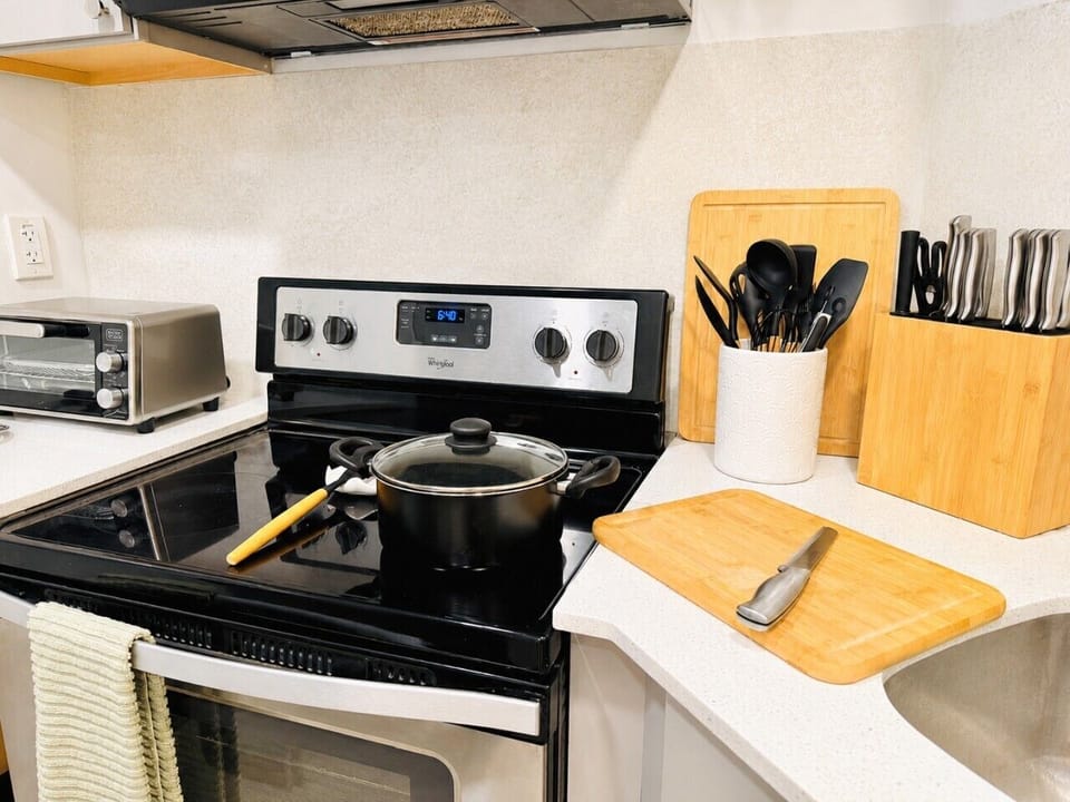 Spacious cooking area with modern appliances, cookware, and kitchen essentials.