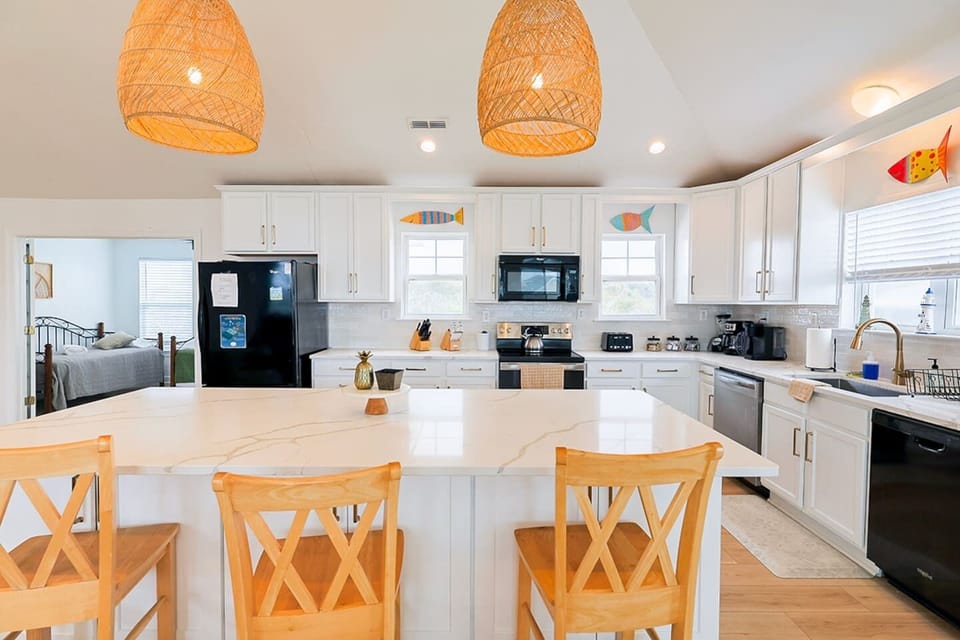 Open-concept kitchen with expansive island and bar seating—designed for connection and convenience.