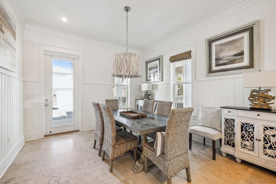 Gather around this elegant dining table where memorable meals and conversations await, surrounded by coastal charm and natural light.