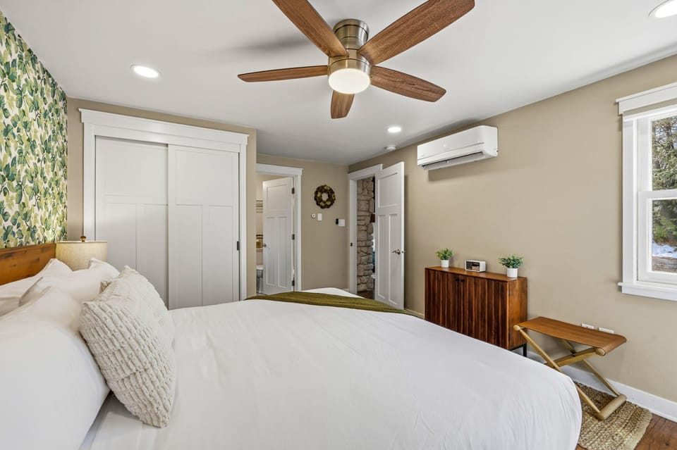 A window brings in natural light and wooded views, making the space feel peaceful and tucked away.
