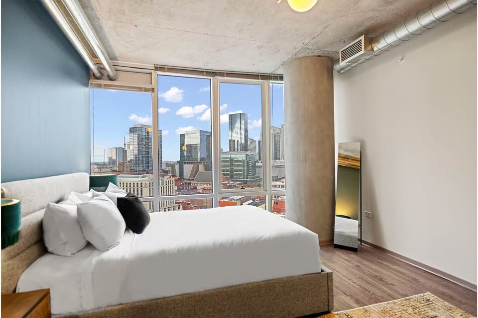 Stretch out in a sunlit bed beside floor-to-ceiling windows.