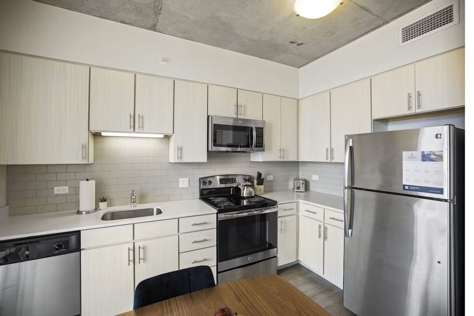 Cook effortlessly in a bright, modern kitchen with full appliances.